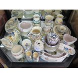 A collection of Honiton and Poole wares, including jugs, jam pots, vases, plates and egg cups