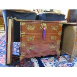 A modern Chinese brass bound hardwood chest of drawers with three long drawers on bracket feet, 69cm