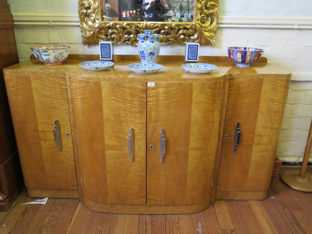 A French Art Deco maple bowfront sideboard, with birds eye maple, the pair of central doors