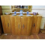 A French Art Deco maple bowfront sideboard, with birds eye maple, the pair of central doors