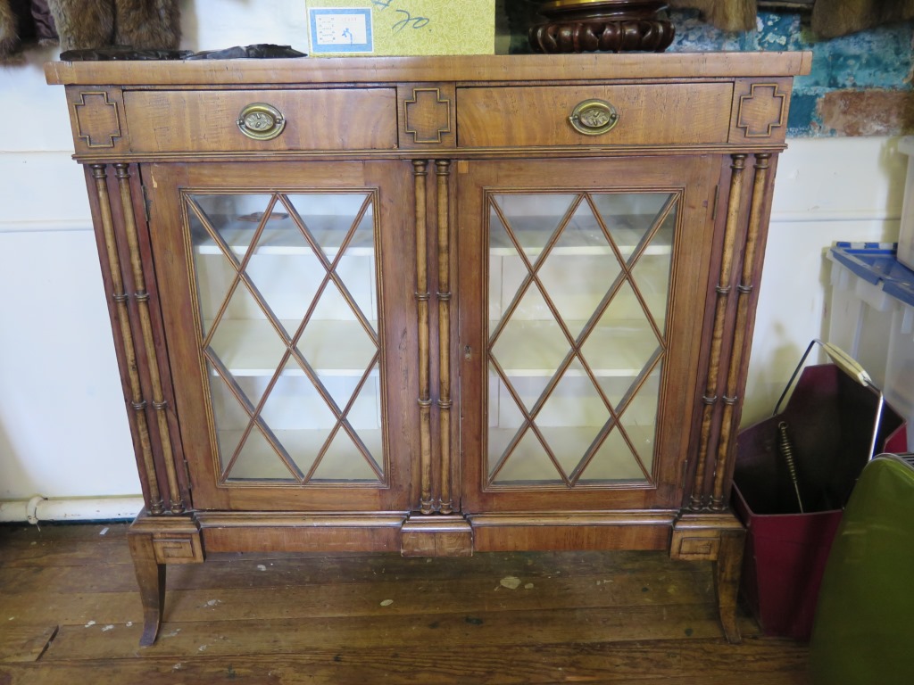 A reproduction Regency style side cabinet, with two frieze drawers, latticework glazed doors and