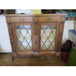 A reproduction Regency style side cabinet, with two frieze drawers, latticework glazed doors and