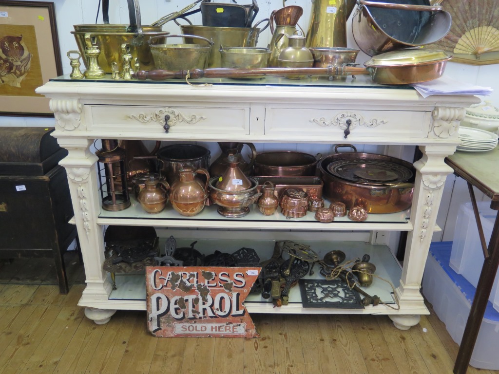 A painted French style buffet, with two frieze drawers over two shelves on husk carved tapering