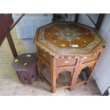 An Indian octagonal ivory and ebony occasional table with folding arched supports, 52cm wide and a