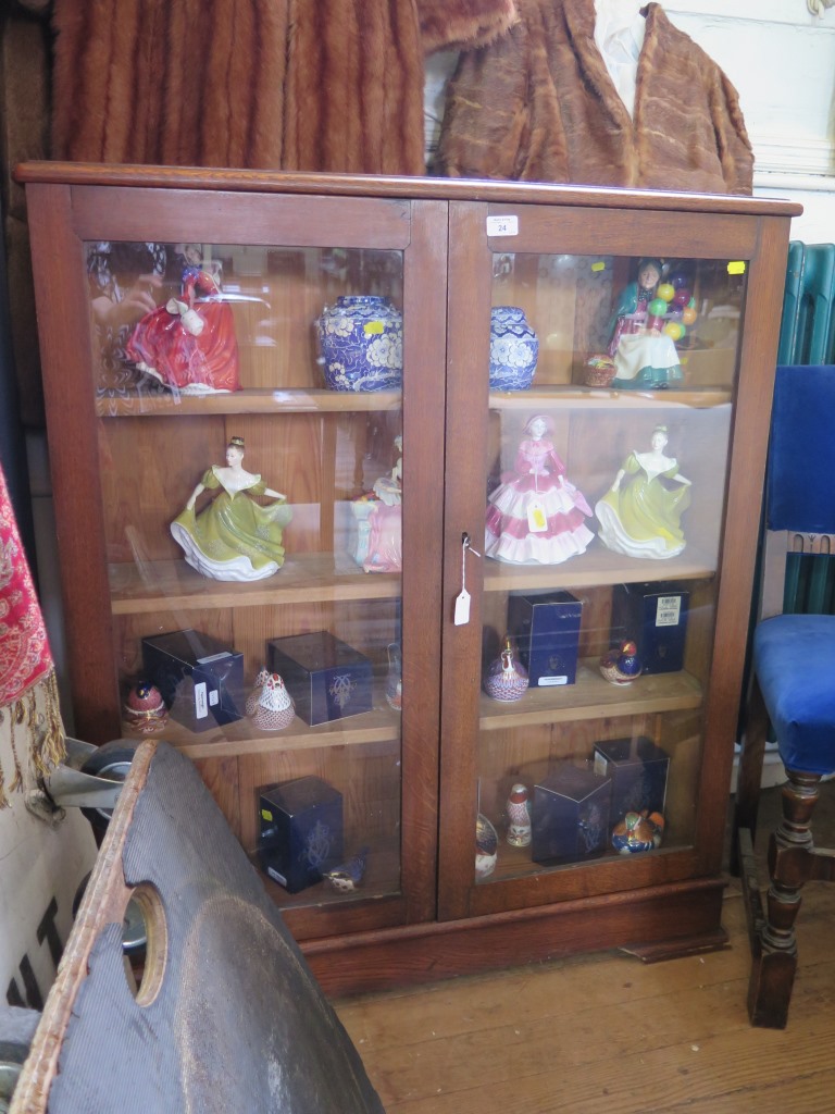 An oak bookcase, with a pair of glazed doors on a plinth base, 93cm wide