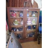 An oak bookcase, with a pair of glazed doors on a plinth base, 93cm wide