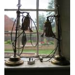 A pair of brass table lights in the Edwardian style, with orange and black coloured shades, retailed