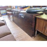 A faux rosewood sideboard, of rectangular form with two pairs of cupboard doors enclosing glass