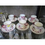 A set of six Victorian teacups and saucers, with red vine decorated handles, diamond registration