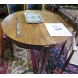 A pair of George III mahogany demi-lune tables, formerly dining table ends, with two brass clips,