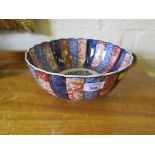 A Japanese Arita lobed bowl with blue and red bands of decoration, chip to footrim, 25cm diameter