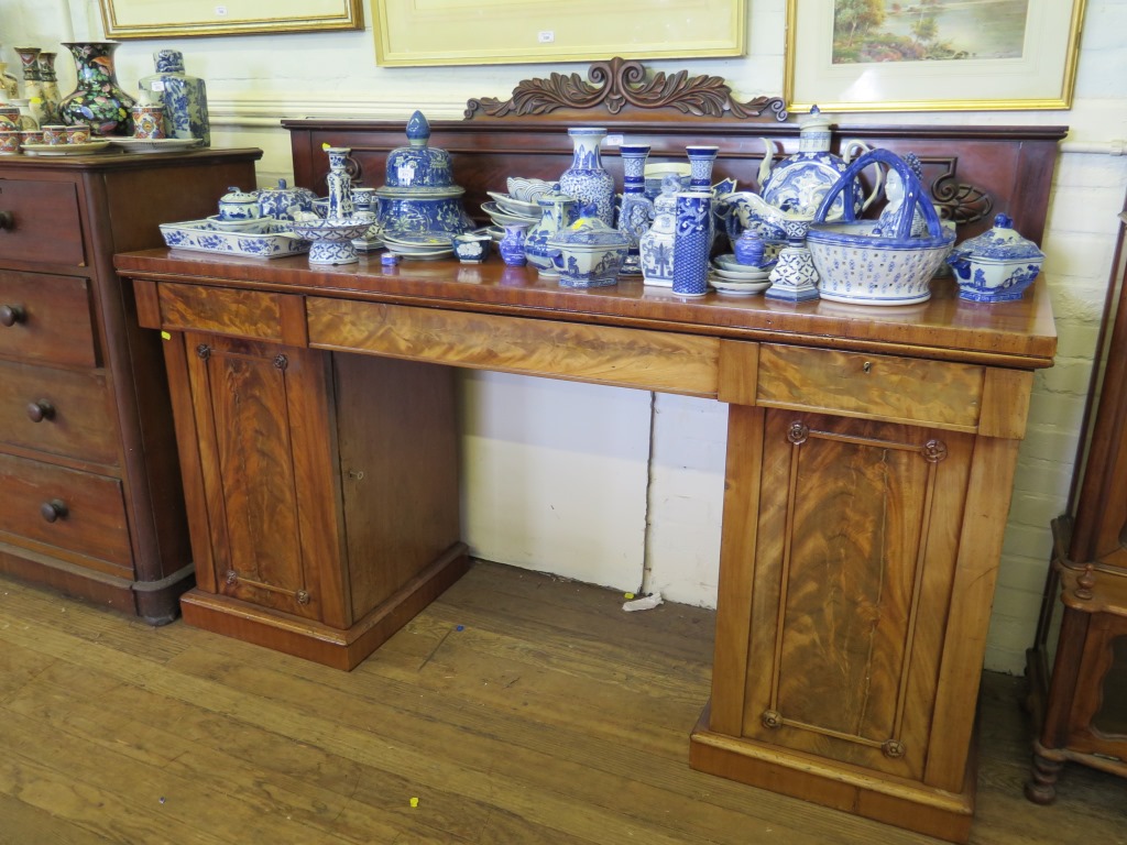 A mid Victorian mahogany pedestal sideboard, the acanthus and anthemion carved back over three