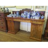 A mid Victorian mahogany pedestal sideboard, the acanthus and anthemion carved back over three