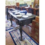 A Chinese Colonial ebonised desk, the panelled top with Greek key border over a floral and bird