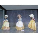 Three Lladro figures of girls in full dresses 21cm high