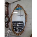 An oval gilt framed mirror, 67cm x 39cm