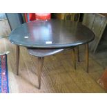 A nest of three Ercol dark stained beech pebble tables, largest 65cm wide, labelled