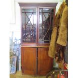 A mahogany bookcase with associated cabinet, the moulded cornice over a pair of glazed doors and
