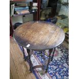 An oak circular occasional table, on barley-twist legs joined by concave stretchers, 66cm