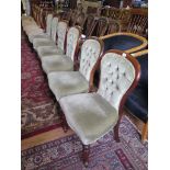 A set of six early Victorian mahogany dining chairs, the button upholstered backs above stuffover