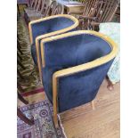 A pair of ash tub armchairs, with black upholstery on outsplayed legs (2)