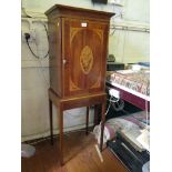 An inlaid crossbanded mahogany cabinet on stand, the frieze and door with greek key border enclosing