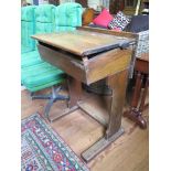 An elm and pine school desk, with sloping hinged top, 60cm wide