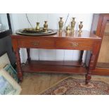 An Edwardian walnut dressing table base, with two drawers, ring turned tapering legs and pot