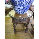 A Spanish walnut circular table with faceted edge over a carved frieze drawer, barley-twist legs and