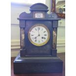A Victorian black slate and marble mantel clock with shaped top and foliate scroll engraving, the
