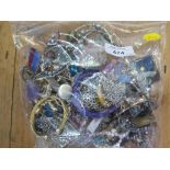A large bag of costume jewellery and a lot of beads
