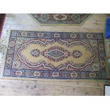 A Louis de Poortere 'Mossoul' carpet, with red field 304cm x 202cm, a similar rug, 150cm x 66cm