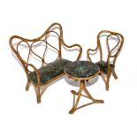 Three items of late 19th century wicker child's toy furniture; the line cloth seats with Japanned