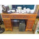 A yew wood reproduction pedestal desk, with keyboard drawer and faux drawer cupboard doors, 109cm