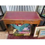 An Edwardian oak ladies desk, the shaped leather inset top over two frieze drawers and carved