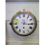 A brass ship's clock, with enamel dial and single train movement 18.5cm diameter
