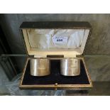 A pair of cased silver napkin rings