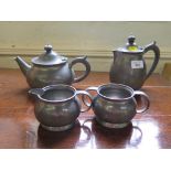 A four piece Liberty & Co hammered pewter tea service, stamped and numbered