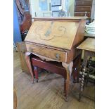 A French walnut bureau, with metal gallery, scroll carved sloping fall and frieze drawer on cabriole