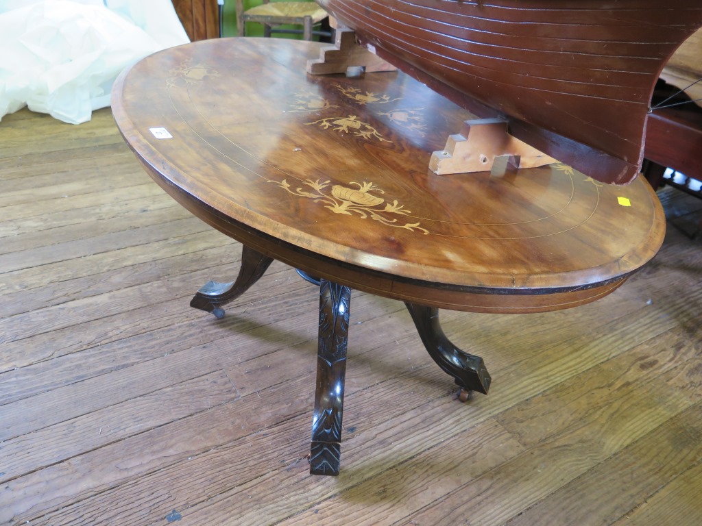 A Victorian inlaid oval table, on four supports and downswept legs, converted into a coffee table,