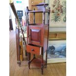 An Edwardian mahogany standing smoker's compendium, with pipe compartments over a cupboard door