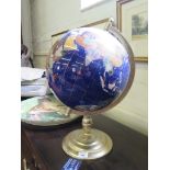 A variegated stone and shell table top globe, on a brass stand approx 30cm diameter