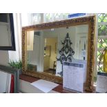 A rectangular scrolling giltwood mirror, with bevelled plate 74cm x 105cm