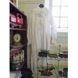 A Victorian linen night dress, with embroidered collar and cuffs