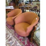 A pair of French 1940's tub chairs, the terracotta colour upholstered seats and backs on turned