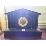 A late Victorian architectural form slate mantel clock with fluted columns and plinth base, the twin