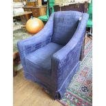 A 1920's upholstered armchair, with square legs on castors and later upholstery