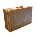 A Louis Vuitton canvas, leather and brass bound 'Bisten' suitcase, numbered 158608 on lock, the