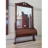A Victorian mahogany dressing wall mirror, with broken pediment, curved hinged compartment and towel