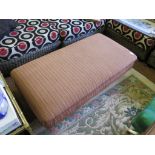 A Victorian style fully upholstered rectangular footstool, on bun feet with brass caps and